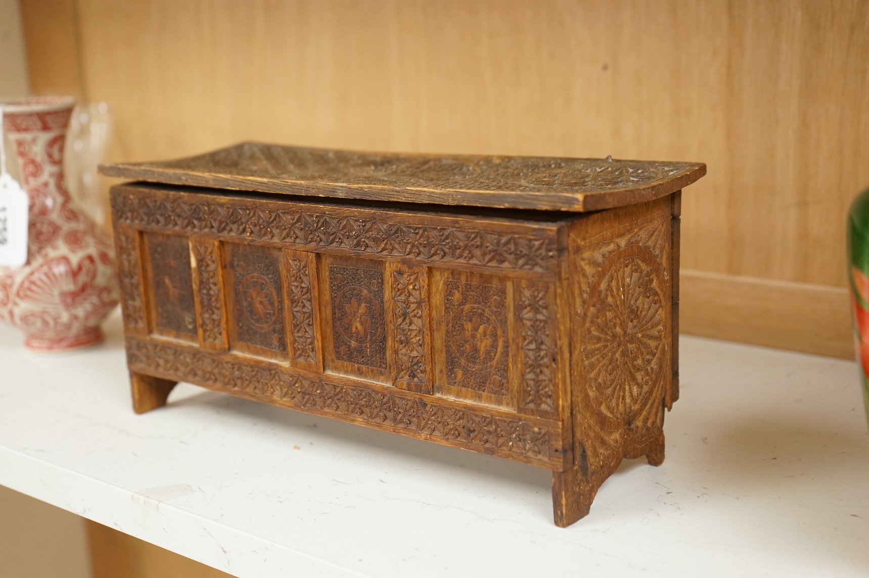 A chip-carved oak miniature coffer with incised date 1901 to the interior, 28cm wide